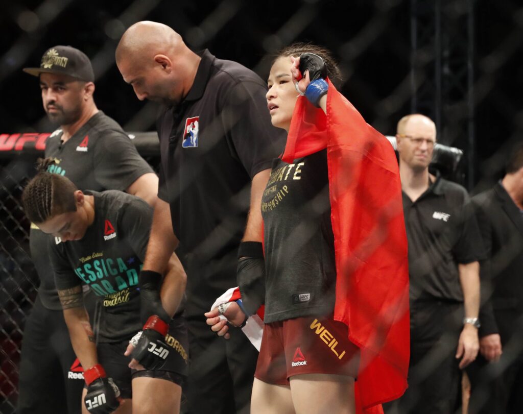 Aug 31, 2019; Shenzhen, China;  Zhang Weili (blue gloves) defeats Jessica Andrade (red gloves) during UFC Fight Night at Shenzhen Universiade Sports Centre. Mandatory Credit: David G. McIntyre-USA TODAY Sports