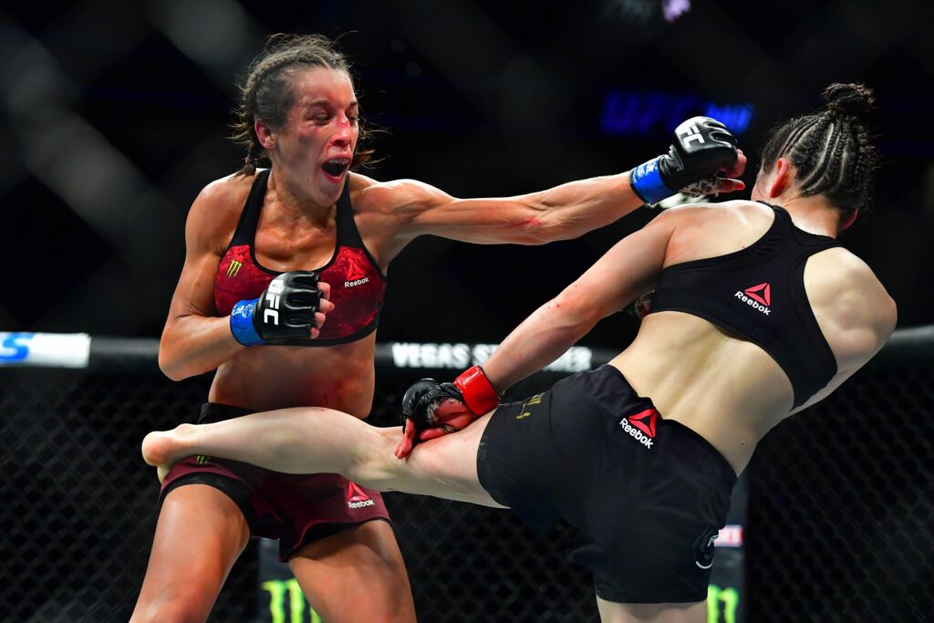 Mar 7, 2020; Las Vegas, Nevada, USA; Weili Zhang (red gloves) fights Joanna Jedrzejczyk (blue gloves) during UFC 248 at T-Mobile Arena. Mandatory Credit: Stephen R. Sylvanie-USA TODAY Sports