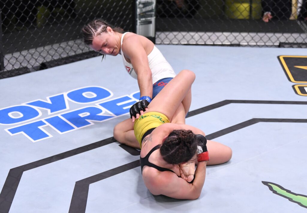 May 30, 2020; Las Vegas, NV, USA; Mackenzie Dern (red gloves) secures a knee bar submission against Hannah Cifers (blue gloves) in their strawweight fight during UFC Fight Night.  Mandatory Credit: Jeff Bottari/Zuffa via USA TODAY Sports