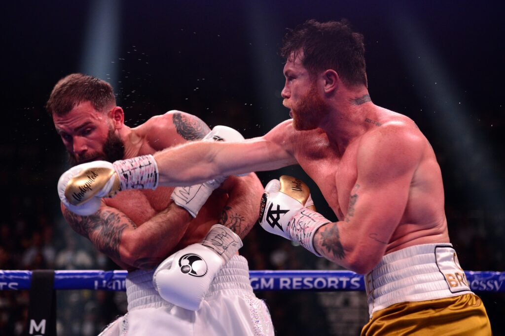 Nov 6, 2021; Las Vegas, Nevada, USA; Canelo Alvarez (gold/white trunks) and Caleb Plant (white/gray trunks) box during their undisputed super middleweight world championship boxing match at MGM Grand Garden Arena. Mandatory Credit: Joe Camporeale-USA TODAY Sports