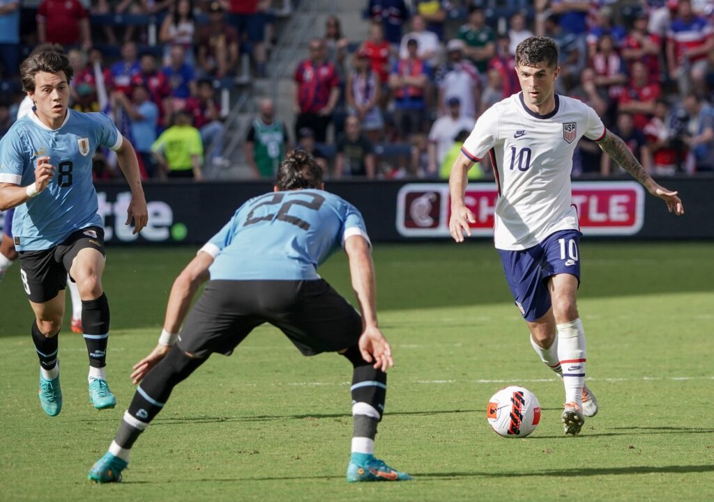 Jun 5, 2022; Kansas City, Kansas, USA; USA forward Christian Pulisic (10) controls the ball as Uruguay defender Martin Caceres (22) defends during an international friendly soccer match at Children's Mercy Park. Mandatory Credit: Denny Medley-USA TODAY Sports