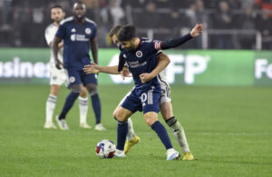 WASHINGTON, DC - MARCH 25: New England Revolution midfielder Carles Gil 10 dribbles while being held during the New England Revolution versus D.C. United Major League Soccer MLS, Fussball Herren, USA game on March 25, 2023 at Audi Field in Washington, D.C.. Photo by Randy Litzinger/Icon Sportswire SOCCER: MAR 25 MLS - D.C. United vs New England Revolution Icon9662303250803