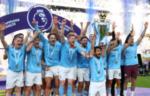 230522 -- MANCHESTER, May 22, 2023 -- Manchester City s players celebrate with the Premier League trophy after the English Premier League football match between Manchester City and Chelsea in Manchester, Britain, May 21, 2023. Manchester City were confirmed as the 2022-2023 Premier League champions on Saturday without having to kick a ball as Arsenal were beaten 1-0 away to Nottingham Forest. SPBRITAIN-MANCHESTER-FOOTBALL-PREMIER LEAGUE-MANCHESTER CITY CELEBRATION XinxHua PUBLICATIONxNOTxINxCHN