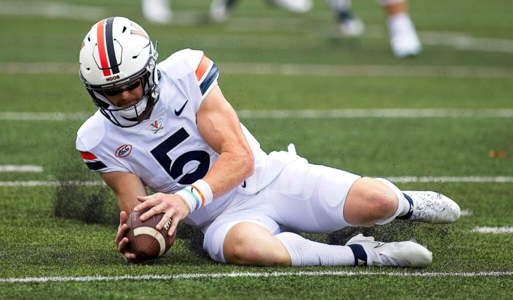 September 10, 2022, Champaign, Illinois, USA: BRENNAN ARMSTRONG recovers a high snap but loses lots of yards and in now pinned close to the goal line. The Cavaliers of the University of Virginia UVA visit the University of Illinois Fighting Illini. Champaign USA - ZUMAl176 20220910_znp_l176_007 Copyright: xAlanxLookx