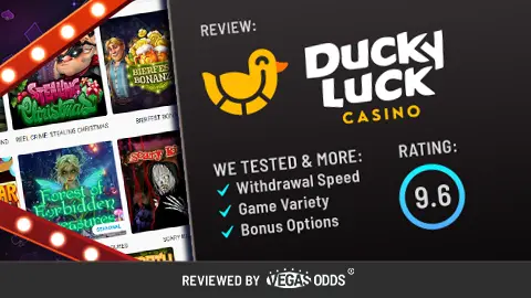 Image of Ducky Luck Casino review showing the Ducky Luck Casino logo on the top right, a score of 9.6 in a blue circle below, and a bullet point list of what has been tested in the review. On the left-hand side, there is an image of slot games available at the casino inside a Vegas-style sign.